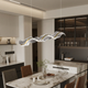 Dining table pendant light height guide with a stylish modern design hanging over a dining table.