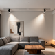 Modern living room showcasing the ceiling-free lighting trend with sleek track lights and minimalistic decor.