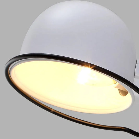 Close-up of a white light fixture with a glowing bulb, illustrating how to clean light fixtures for a brighter home.